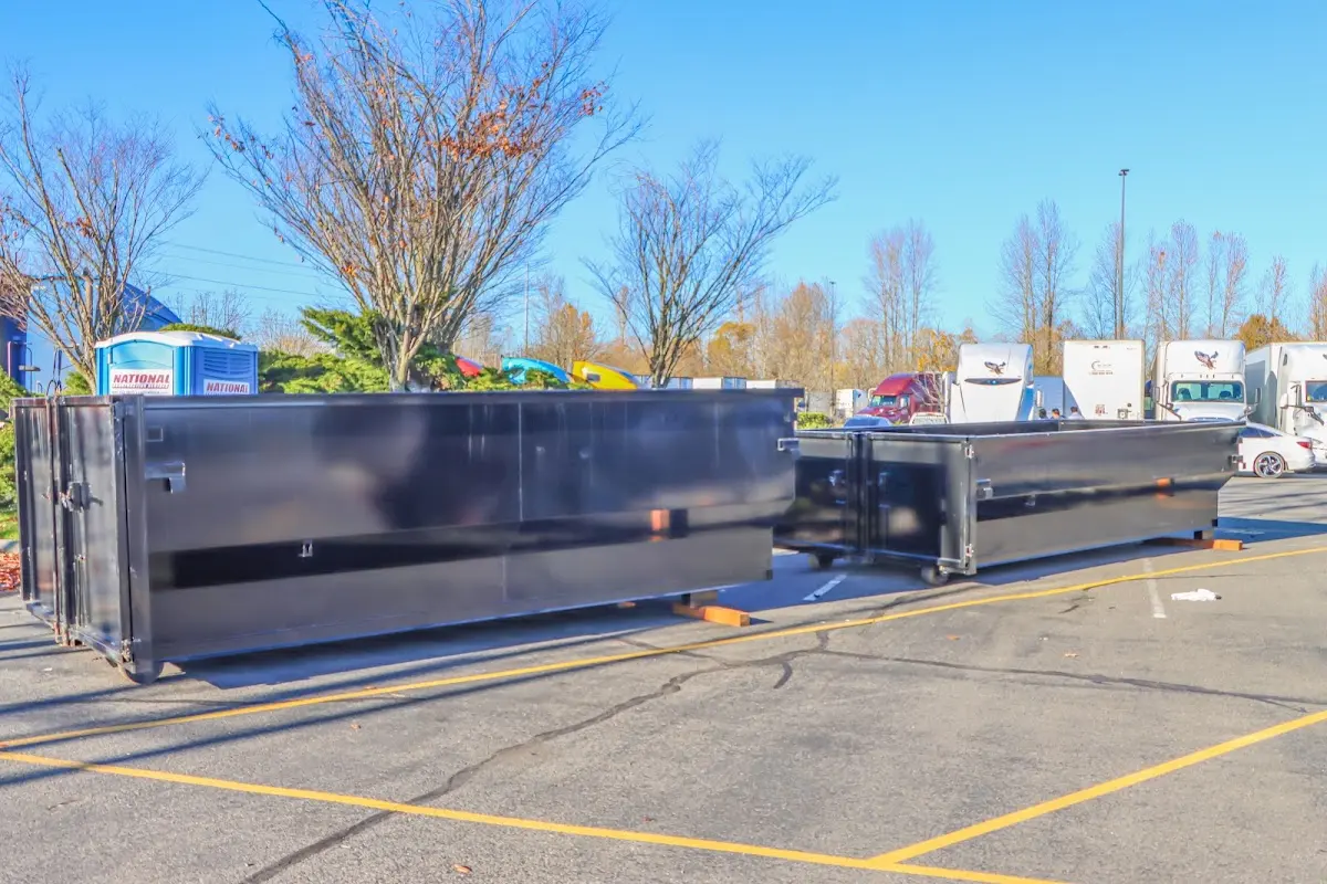 Professional dumpster rental service with roll-off container on residential driveway in Hampshire